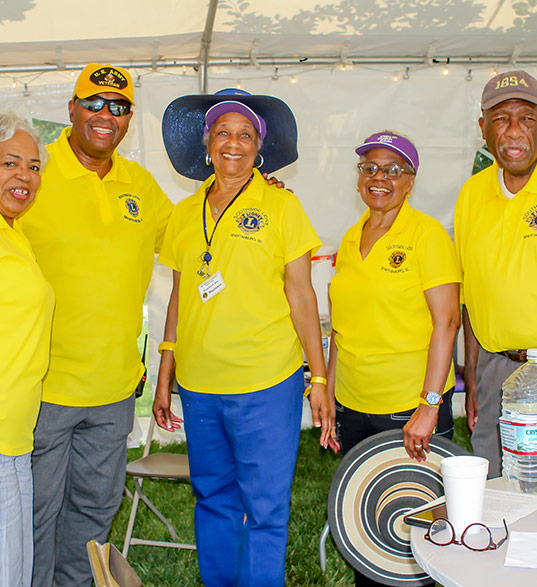 group of Lions Club members in yellow shirts